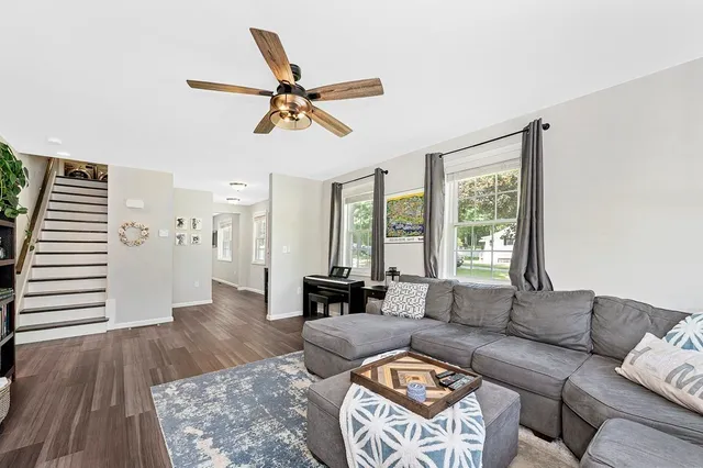 a living room with furniture and wooden floor