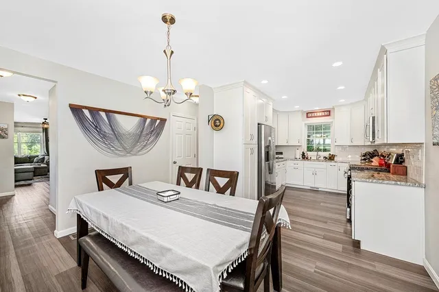 a view of a dining room with furniture and a chandelier