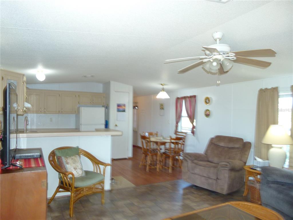 1017 1st Street Okeechobee, FL 34974 - Photo 12 of 36 a living room with furniture and a chandelier