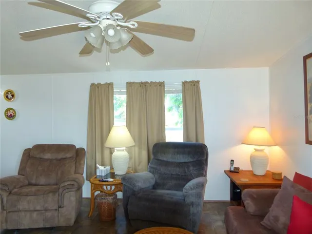 a living room with furniture a lamp and a chandelier