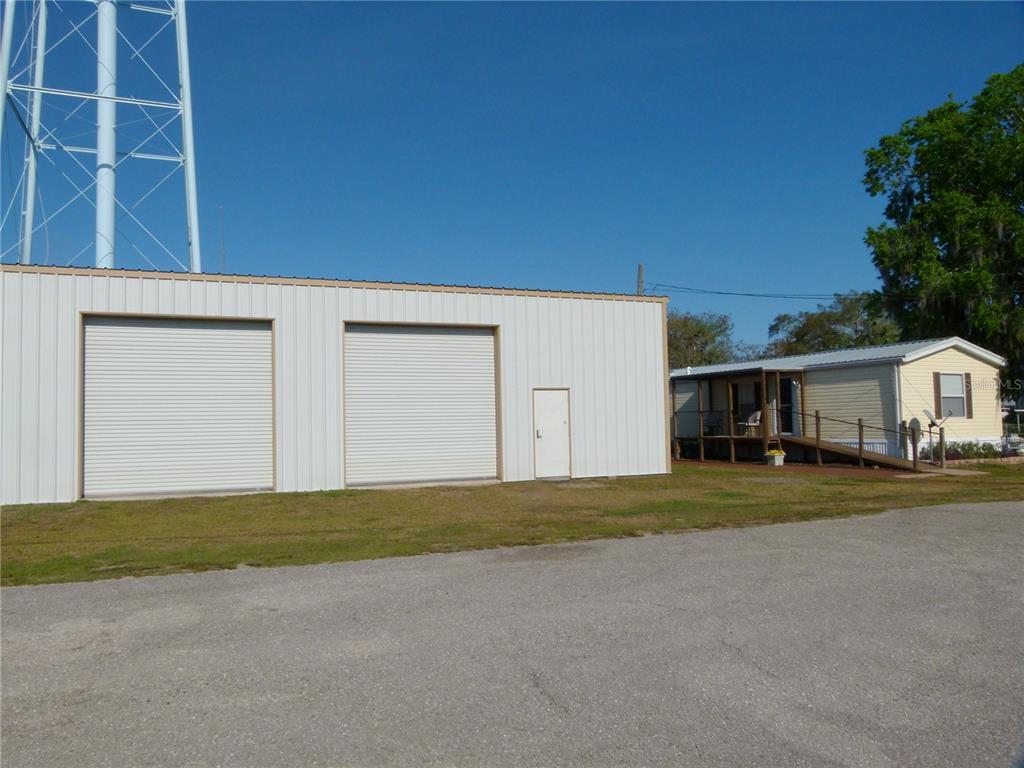 1017 1st Street Okeechobee, FL 34974 - Photo 2 of 36 a front view of a house with a garden