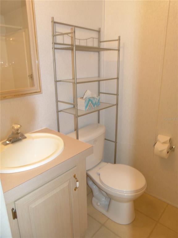 1017 1st Street Okeechobee, FL 34974 - Photo 21 of 36 a bathroom with a sink a toilet and a mirror