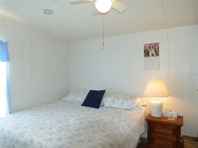 a bedroom with a bed and a lamp