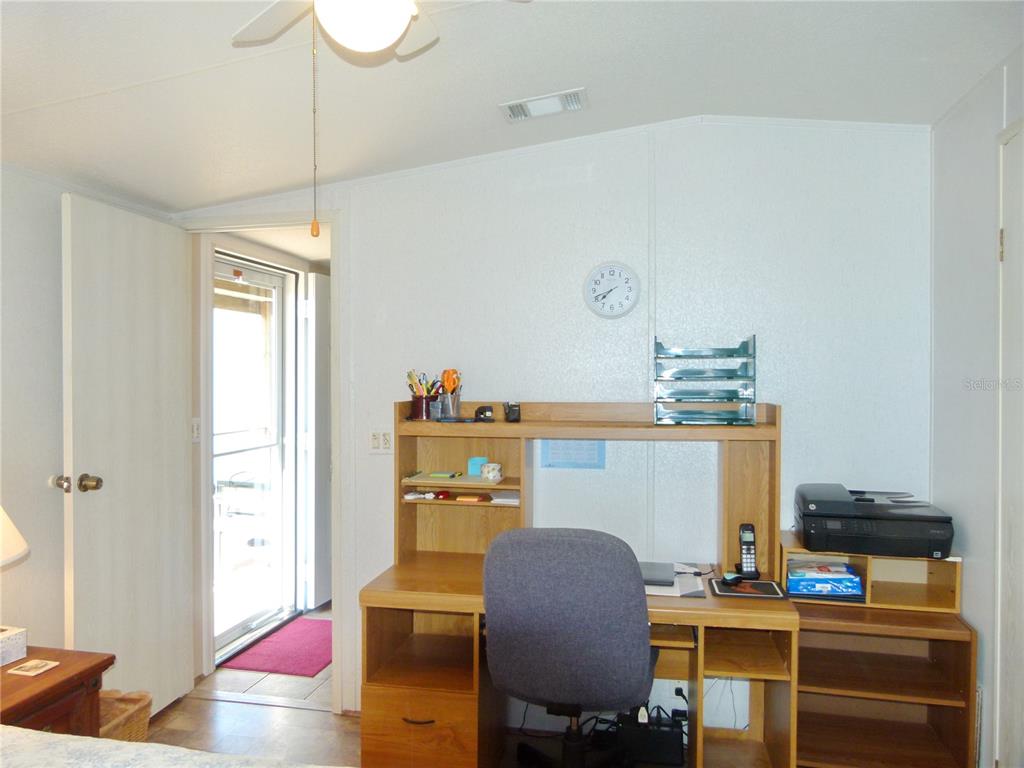 1017 1st Street Okeechobee, FL 34974 - Photo 24 of 36 a room with furniture and a chandelier