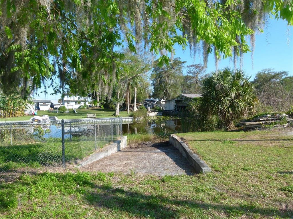 1017 1st Street Okeechobee, FL 34974 - Photo 25 of 36 a view of a lake with a yard and large trees