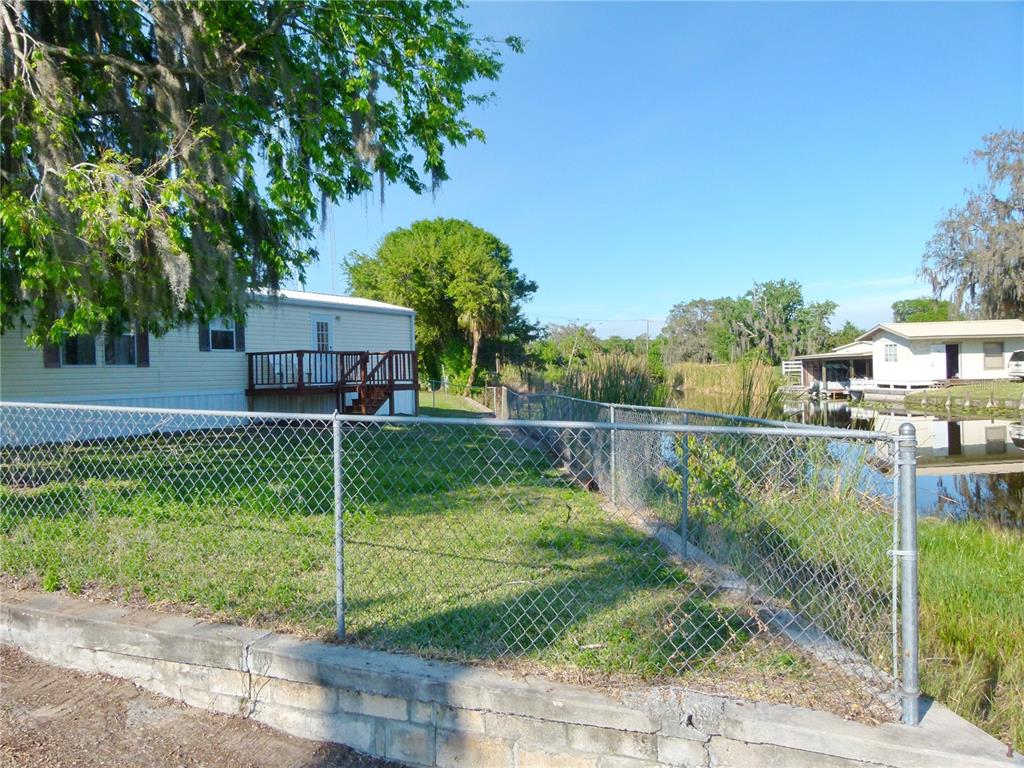 1017 1st Street Okeechobee, FL 34974 - Photo 6 of 36 a front view of a house with a yard