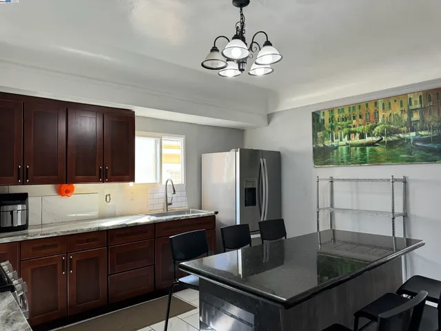 a kitchen with a table and chairs