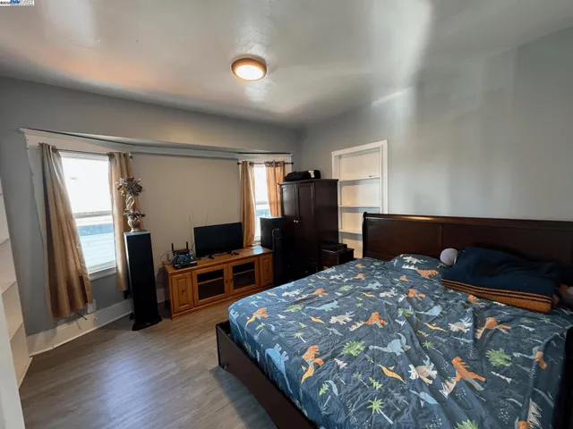 a bedroom with a bed and a flat screen tv