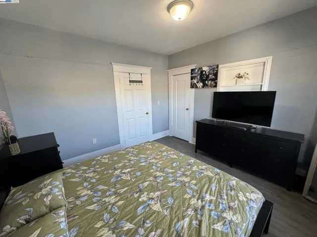 a bedroom with a bed and a television