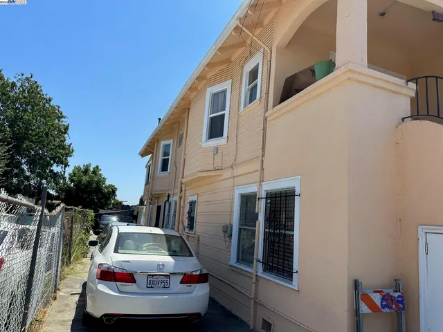 a car parked in front of white building