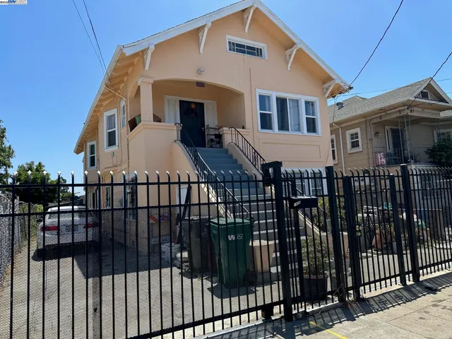 a view of a house with iron stairs