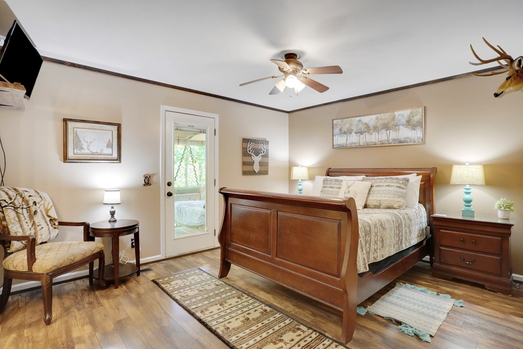 41 Courtside Court Ellijay, GA 30540 - Photo 14 of 34 a bedroom with a bed and a chandelier