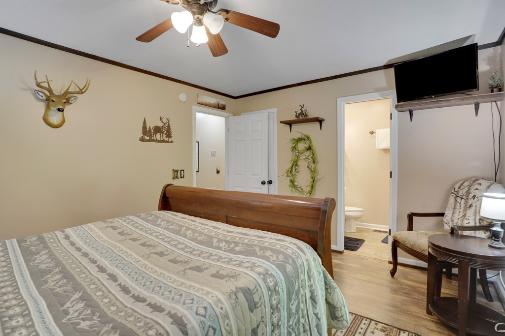 41 Courtside Court Ellijay, GA 30540 - Photo 23 of 34 a bedroom with a large bed and a flat screen tv