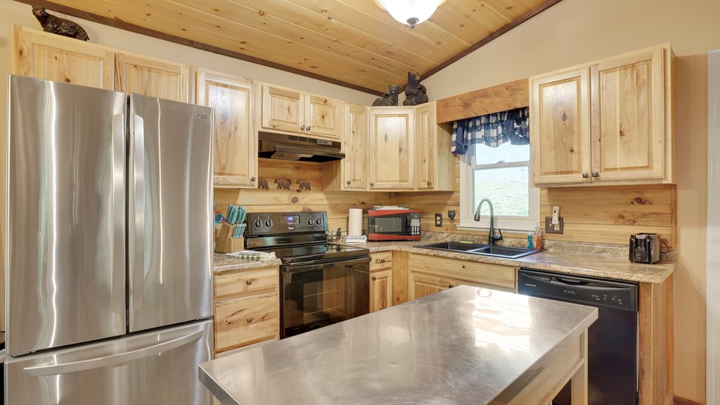 41 Courtside Court Ellijay, GA 30540 - Photo 4 of 34 a kitchen with stainless steel appliances granite countertop a refrigerator a sink a stove a washer and dryer
