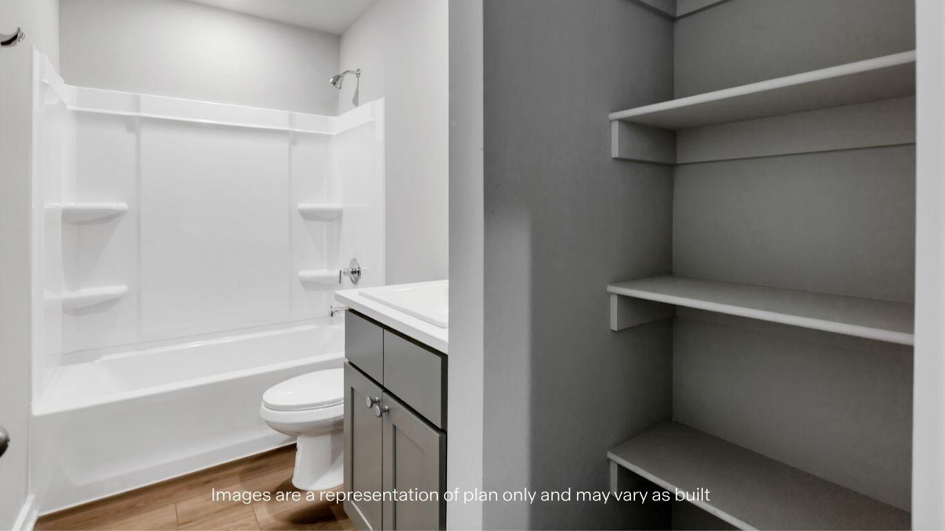 224 18th Street Wolfforth, TX 79382 - Photo 18 of 27 a bathroom with a toilet and a bathtub