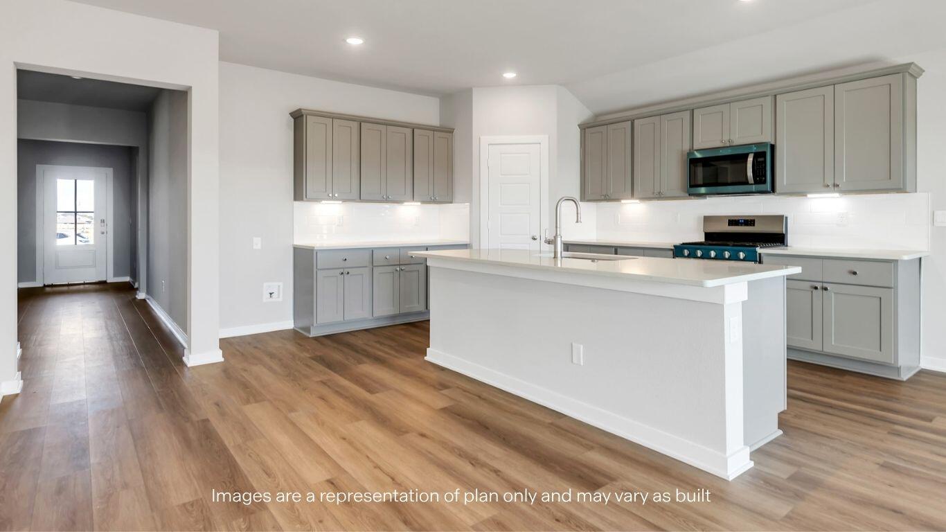 224 18th Street Wolfforth, TX 79382 - Photo 7 of 27 a kitchen with a sink cabinets and wooden floor