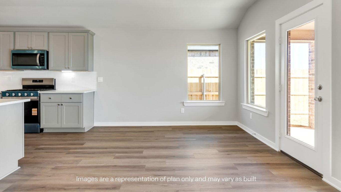 224 18th Street Wolfforth, TX 79382 - Photo 10 of 27 a view of a kitchen with wooden floor and electronic appliances
