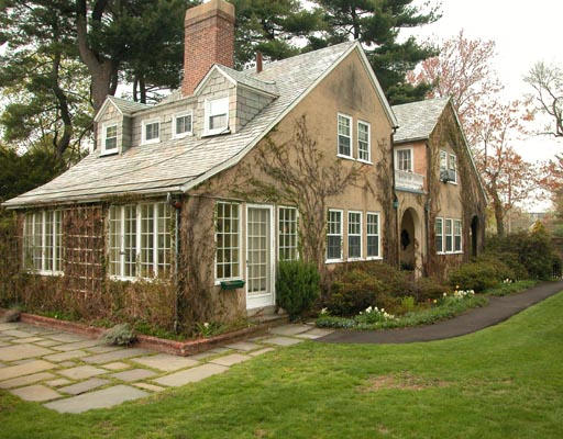 7 Pine Road Brookline, MA 02467 - Photo 1 of 1 a view of a white house next to a yard with plants and trees
