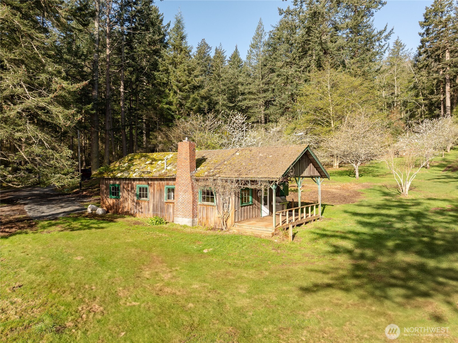 557 Old Sentinel Road Orcas Island, WA 98279 - Photo 28 of 40 a view of a house with a big yard and large trees