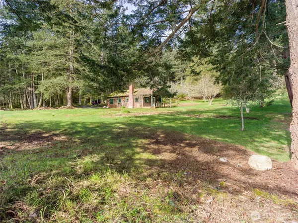 a front view of house with yard and trees