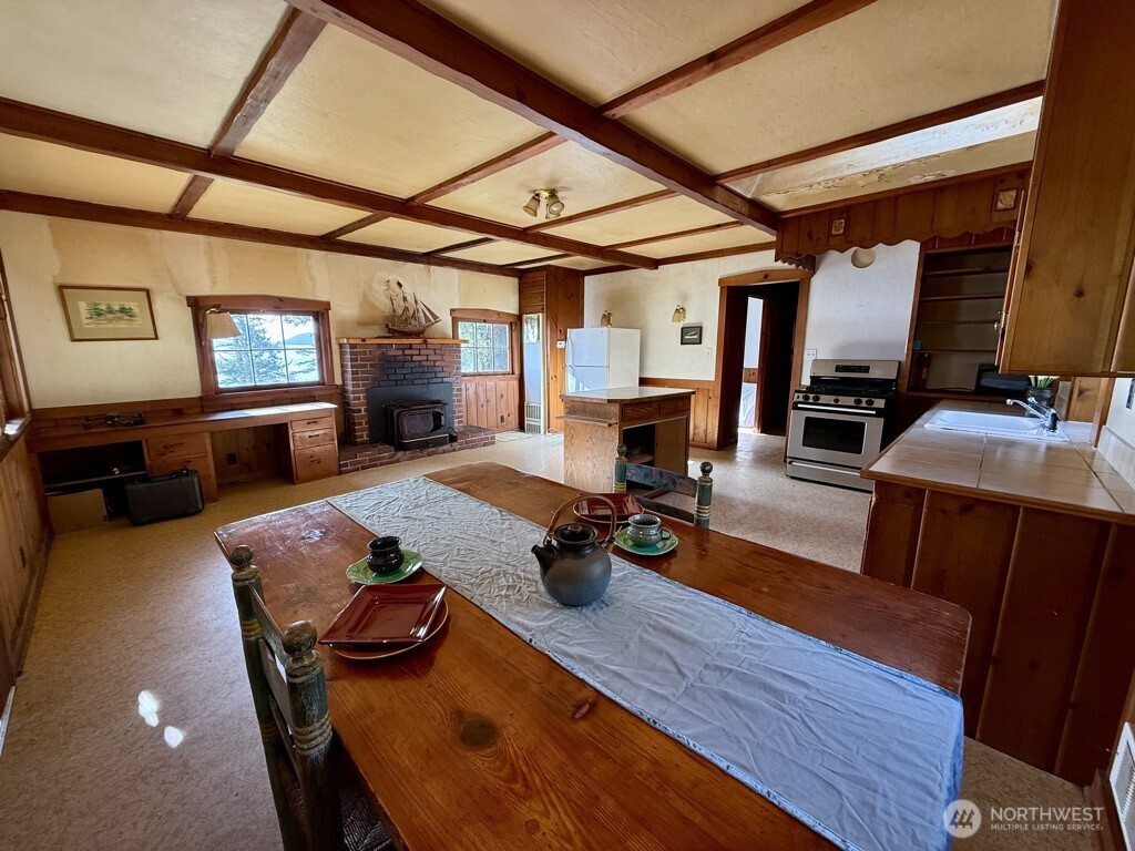 557 Old Sentinel Road Orcas Island, WA 98279 - Photo 37 of 40 a view of a dining room with furniture a chandelier and wooden floor