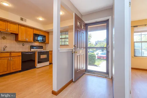 a view of kitchen with stainless steel appliances granite countertop a stove top oven