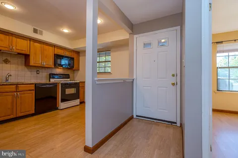 a kitchen with stainless steel appliances granite countertop a stove top oven and sink
