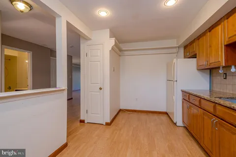 a view of a kitchen with a sink and a refrigerator