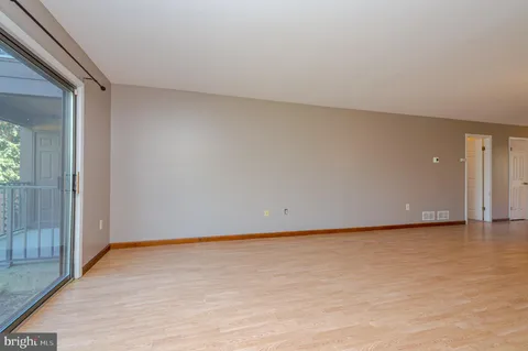 a view of an empty room and wooden floor
