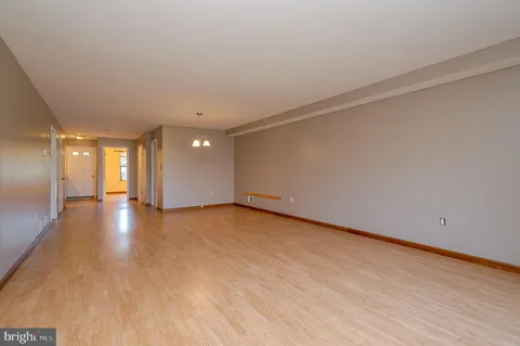 a view of a room with wooden floor