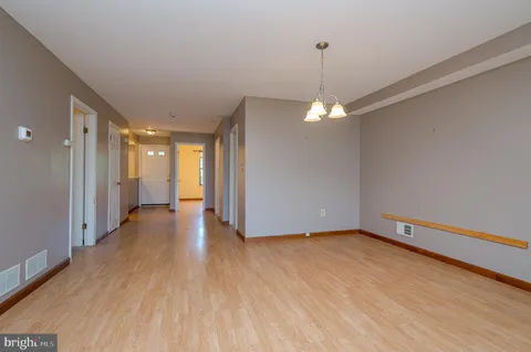 a view of a room with wooden floor and a window