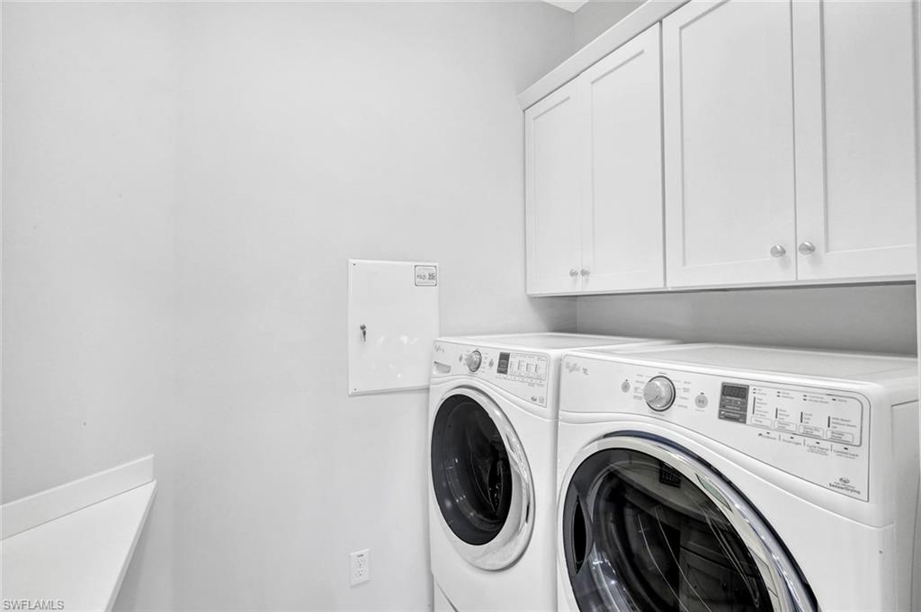 9311 Fieldstone Lane Naples, FL 34120 - Photo 11 of 48 a view of kitchen with washer and dryer