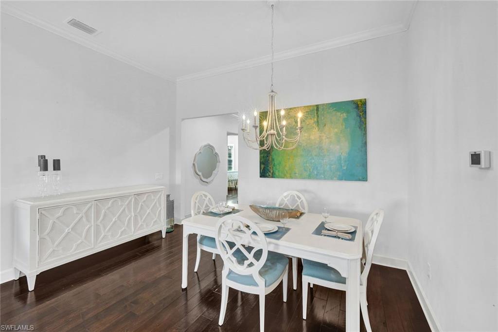 9311 Fieldstone Lane Naples, FL 34120 - Photo 15 of 48 a view of a dining room with furniture window and wooden floor