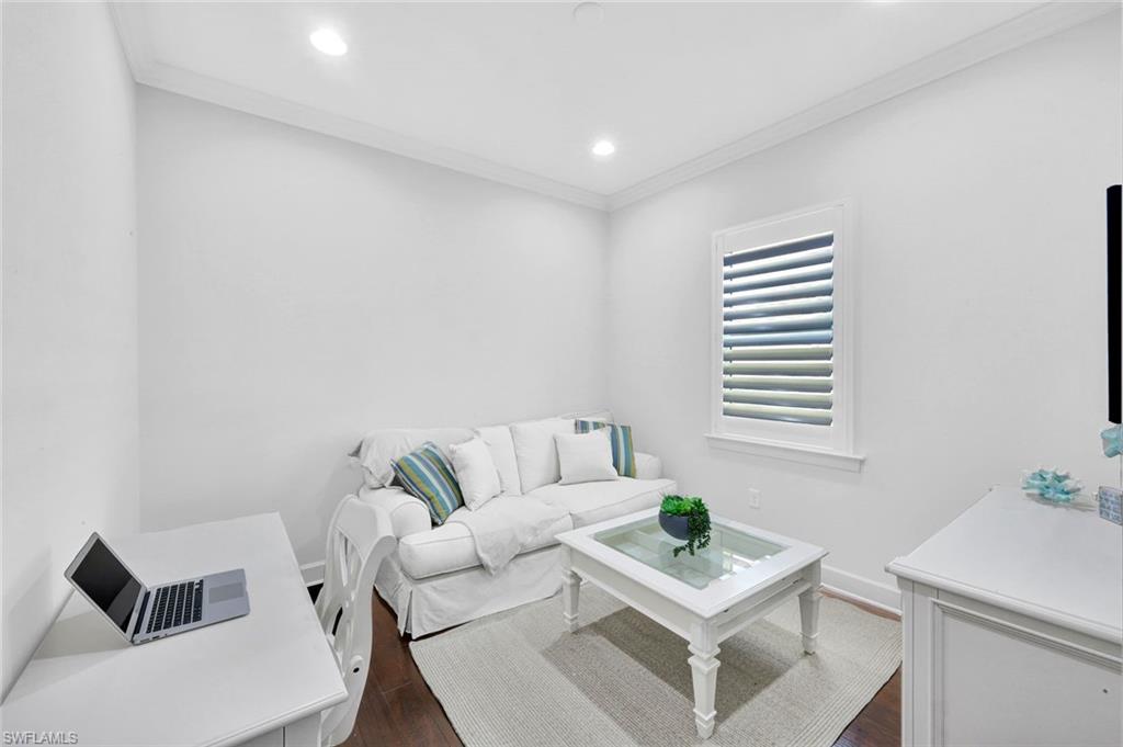 9311 Fieldstone Lane Naples, FL 34120 - Photo 16 of 48 a living room with furniture and a window
