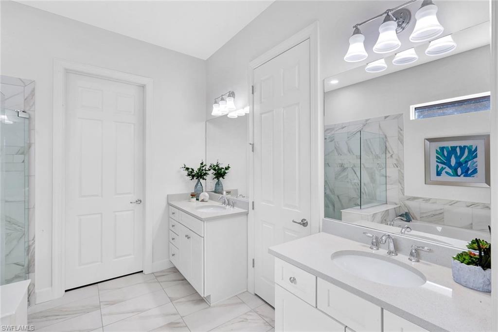 9311 Fieldstone Lane Naples, FL 34120 - Photo 20 of 48 a bathroom with a sink vanity and a mirror