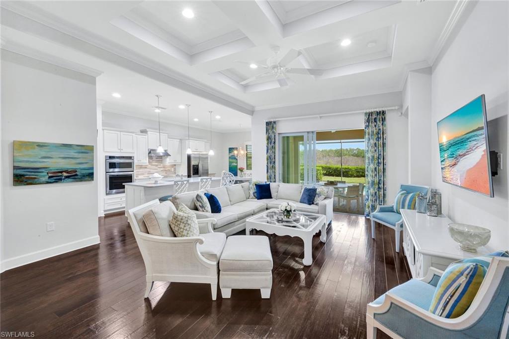 9311 Fieldstone Lane Naples, FL 34120 - Photo 2 of 48 a view of a dining room with furniture a rug and wooden floor