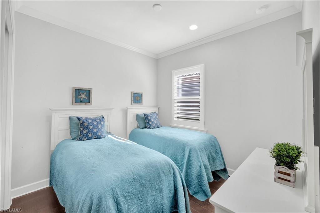 9311 Fieldstone Lane Naples, FL 34120 - Photo 24 of 48 a bedroom with a bed and windows