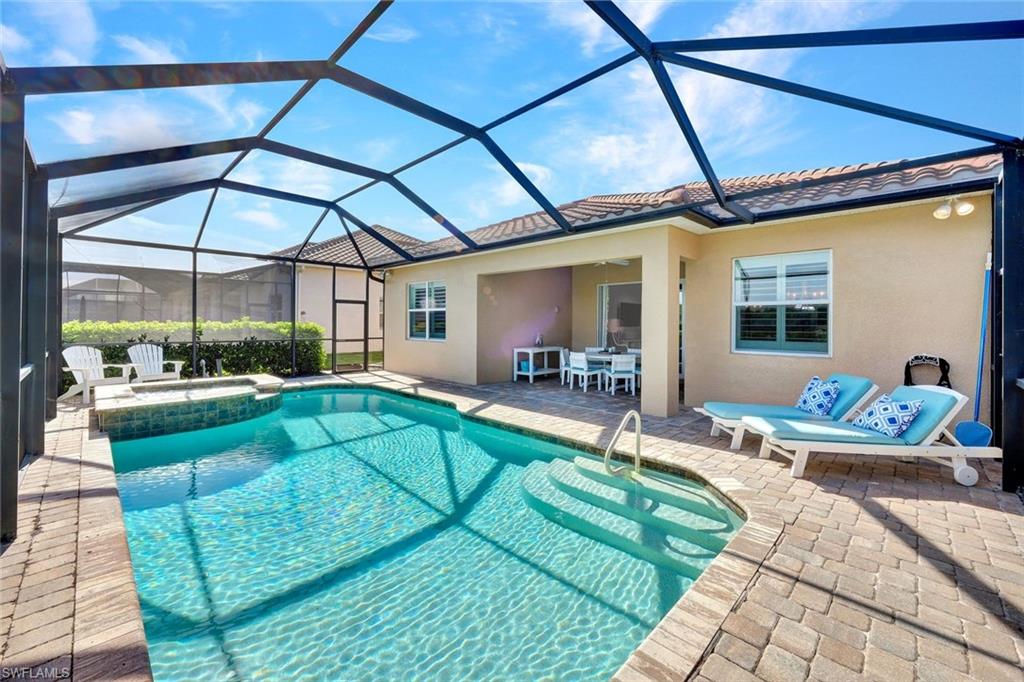 9311 Fieldstone Lane Naples, FL 34120 - Photo 27 of 48 a swimming pool with outdoor seating and patio