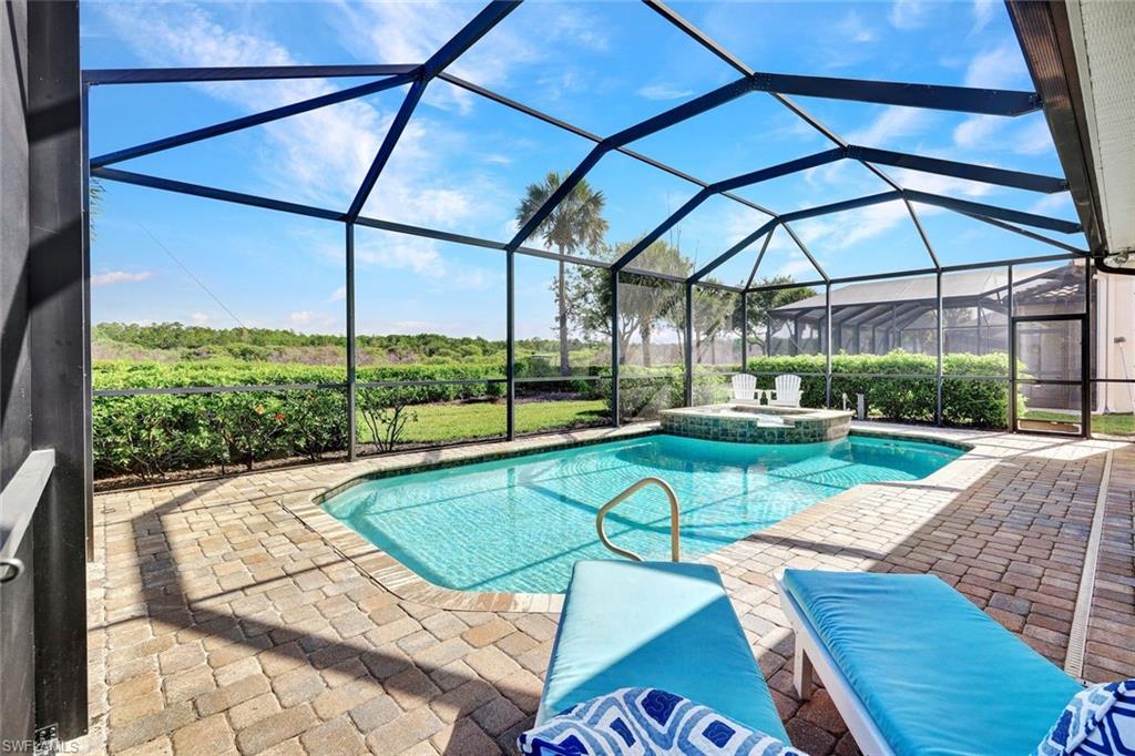 9311 Fieldstone Lane Naples, FL 34120 - Photo 29 of 48 a view of backyard with swimming pool and outdoor seating