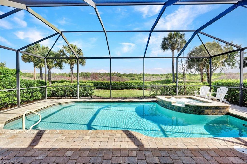 9311 Fieldstone Lane Naples, FL 34120 - Photo 30 of 48 a view of a swimming pool with a yard