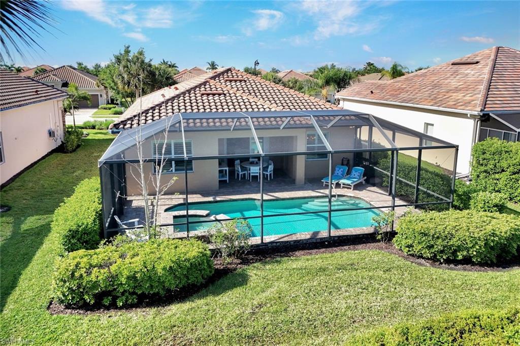 9311 Fieldstone Lane Naples, FL 34120 - Photo 32 of 48 a front view of a house with a yard table and chairs