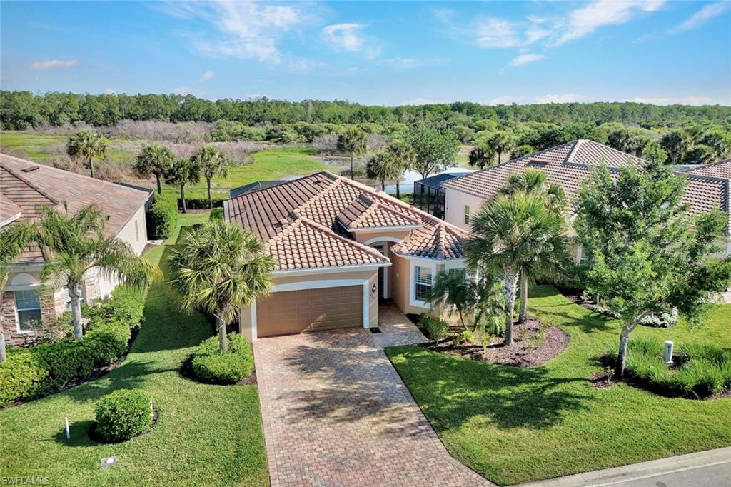9311 Fieldstone Lane Naples, FL 34120 - Photo 33 of 48 a aerial view of a house with a yard and lake view