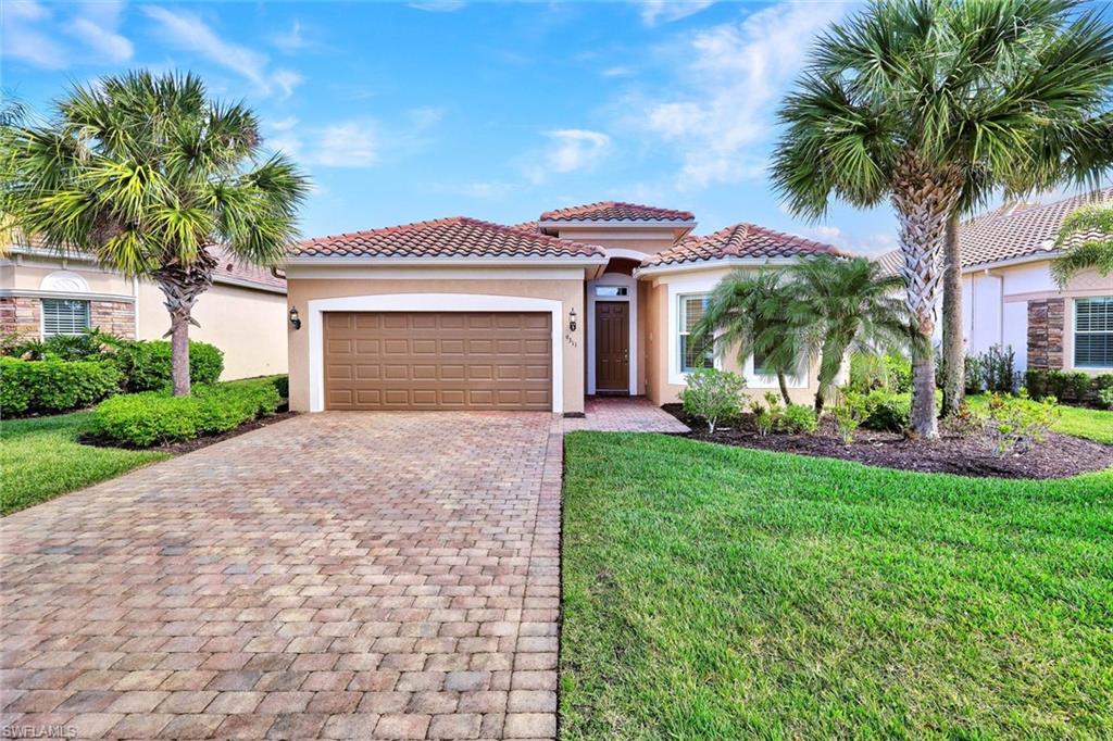 9311 Fieldstone Lane Naples, FL 34120 - Photo 34 of 48 a front view of a house with garden