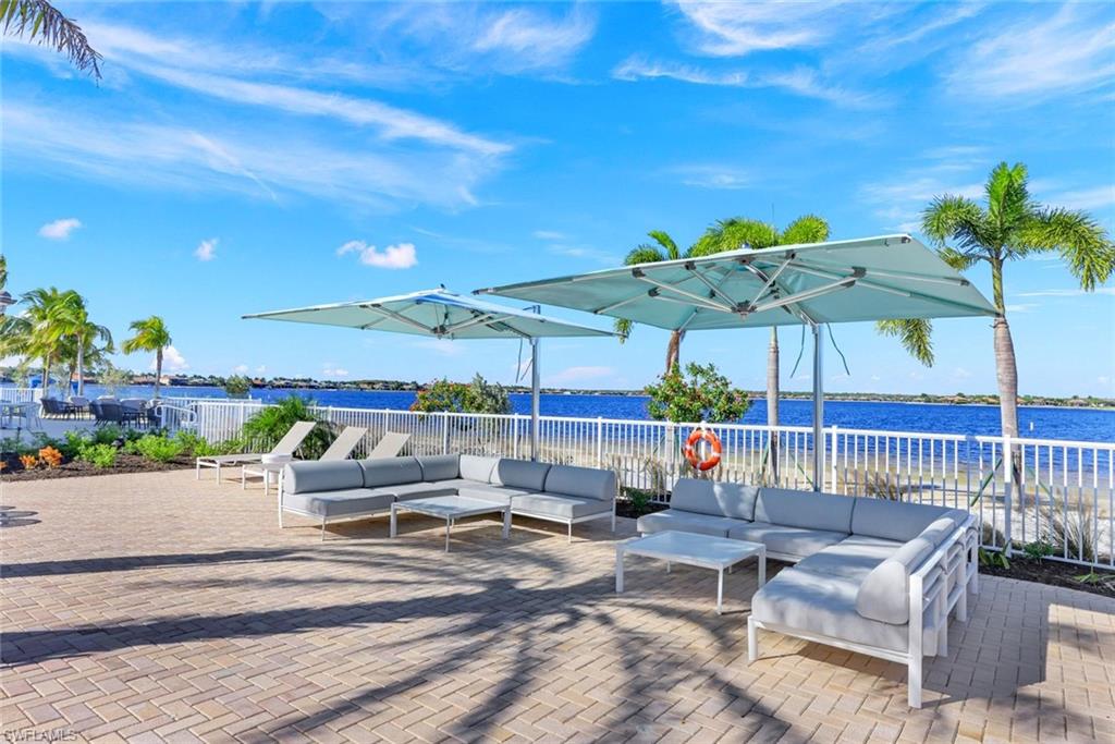 9311 Fieldstone Lane Naples, FL 34120 - Photo 44 of 48 a outdoor space with patio lots of furniture and umbrella