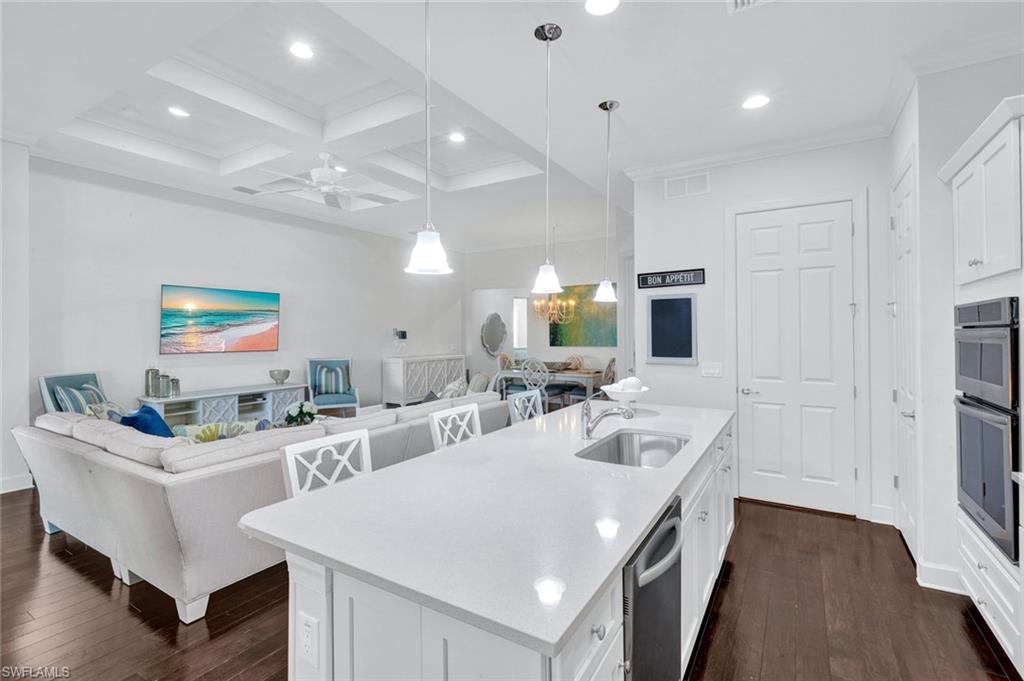 9311 Fieldstone Lane Naples, FL 34120 - Photo 8 of 48 a large white kitchen with a sink a counter space and stainless steel appliances