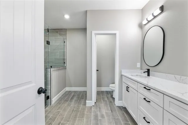 a bathroom with a double vanity sink a mirror and a shower