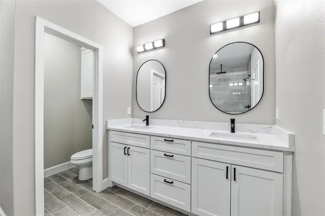 a bathroom with 2 sink and a mirror