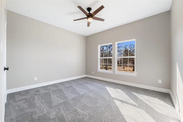 a view of a livingroom with a ceiling fan and window