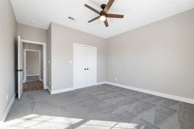 a view of a livingroom with a ceiling fan and window