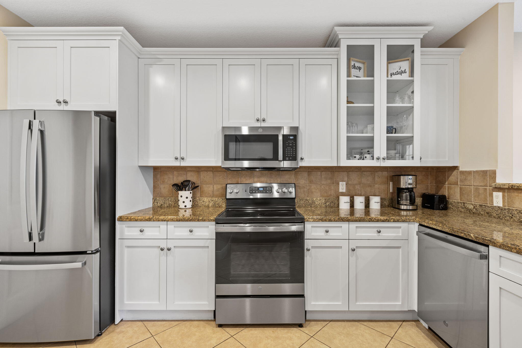 462 Ocean Ridge Way Juno Beach, FL 33408 - Photo 13 of 74 a kitchen with stainless steel appliances granite countertop a stove and a refrigerator